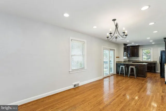 a view of kitchen with microwave and refrigerator
