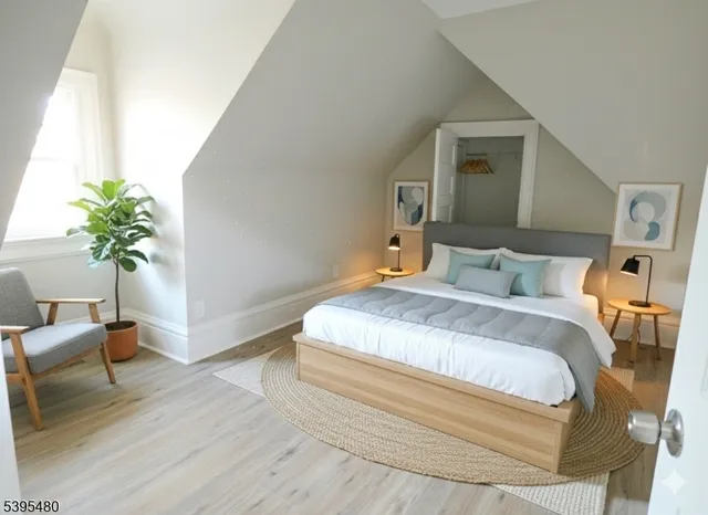 a bedroom with bed and wooden floor