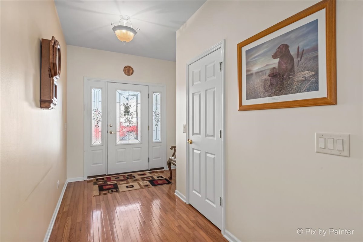 1 Suffolk Way Grayslake, IL 60030 - Photo 13 of 54 a view of a hallway with wooden floor and windows