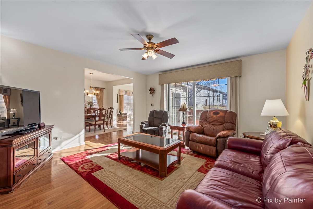 1 Suffolk Way Grayslake, IL 60030 - Photo 15 of 54 a living room with furniture a ceiling fan a lamp and a window
