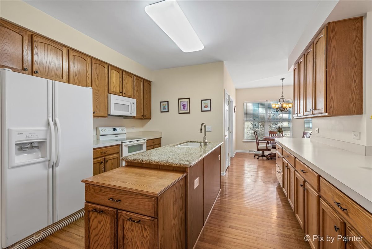 1 Suffolk Way Grayslake, IL 60030 - Photo 18 of 54 a kitchen with stainless steel appliances granite countertop a refrigerator a stove and a wooden floors