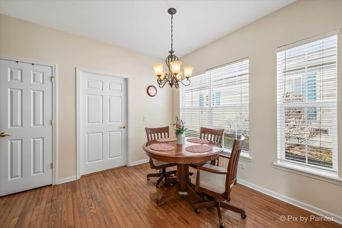 1 Suffolk Way Grayslake, IL 60030 - Photo 21 of 54 a dining room with furniture a chandelier and wooden floor
