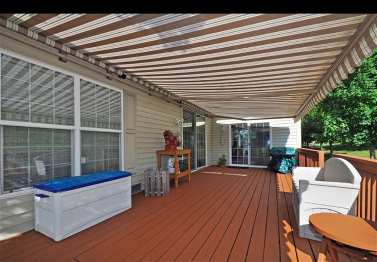 1 Suffolk Way Grayslake, IL 60030 - Photo 8 of 54 a view of a patio with table and chairs with wooden floor and fence and a floor to ceiling window