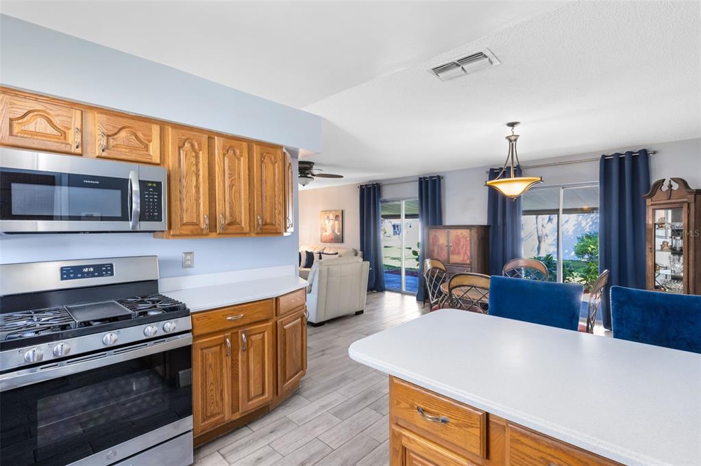 5331 Maize Street Orlando, FL 32821 - Photo 12 of 35 a kitchen with sink a stove and cabinets