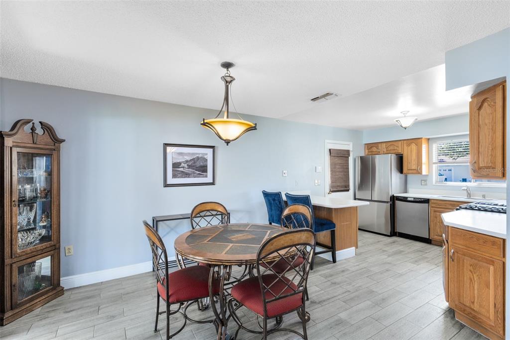 5331 Maize Street Orlando, FL 32821 - Photo 15 of 35 a view of a dining room with furniture window and wooden floor