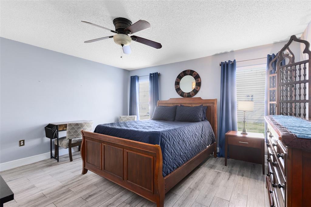 5331 Maize Street Orlando, FL 32821 - Photo 17 of 35 a bed room with a bed and a chandelier