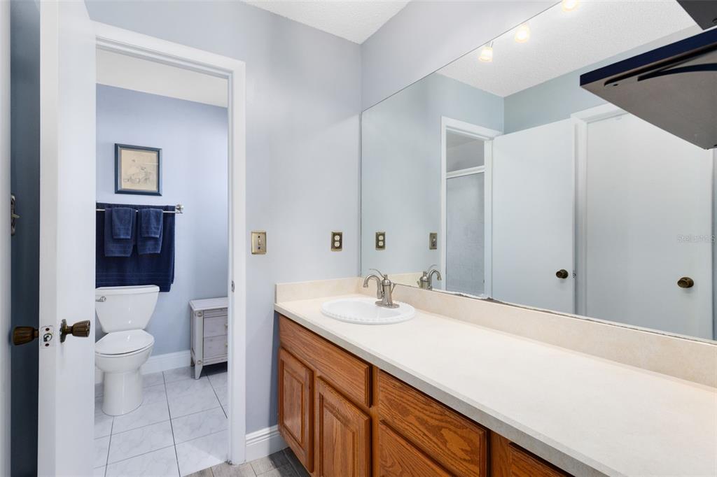 5331 Maize Street Orlando, FL 32821 - Photo 18 of 35 a bathroom with a sink a toilet and shower