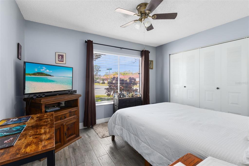 5331 Maize Street Orlando, FL 32821 - Photo 20 of 35 a bedroom with a bed and a flat screen tv