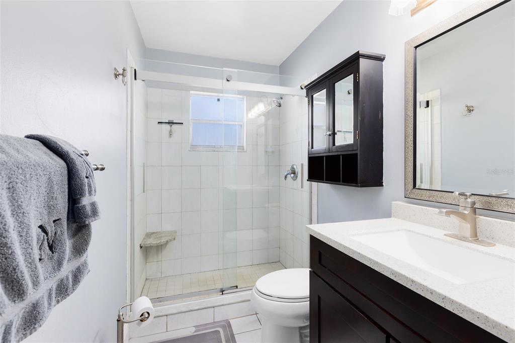 5331 Maize Street Orlando, FL 32821 - Photo 21 of 35 a bathroom with a sink a toilet and shower