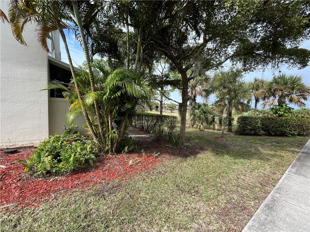 884 Hampton Circle, Unit 159 Naples, FL 34105 - Photo 25 of 28 a backyard of a house with lots of green space