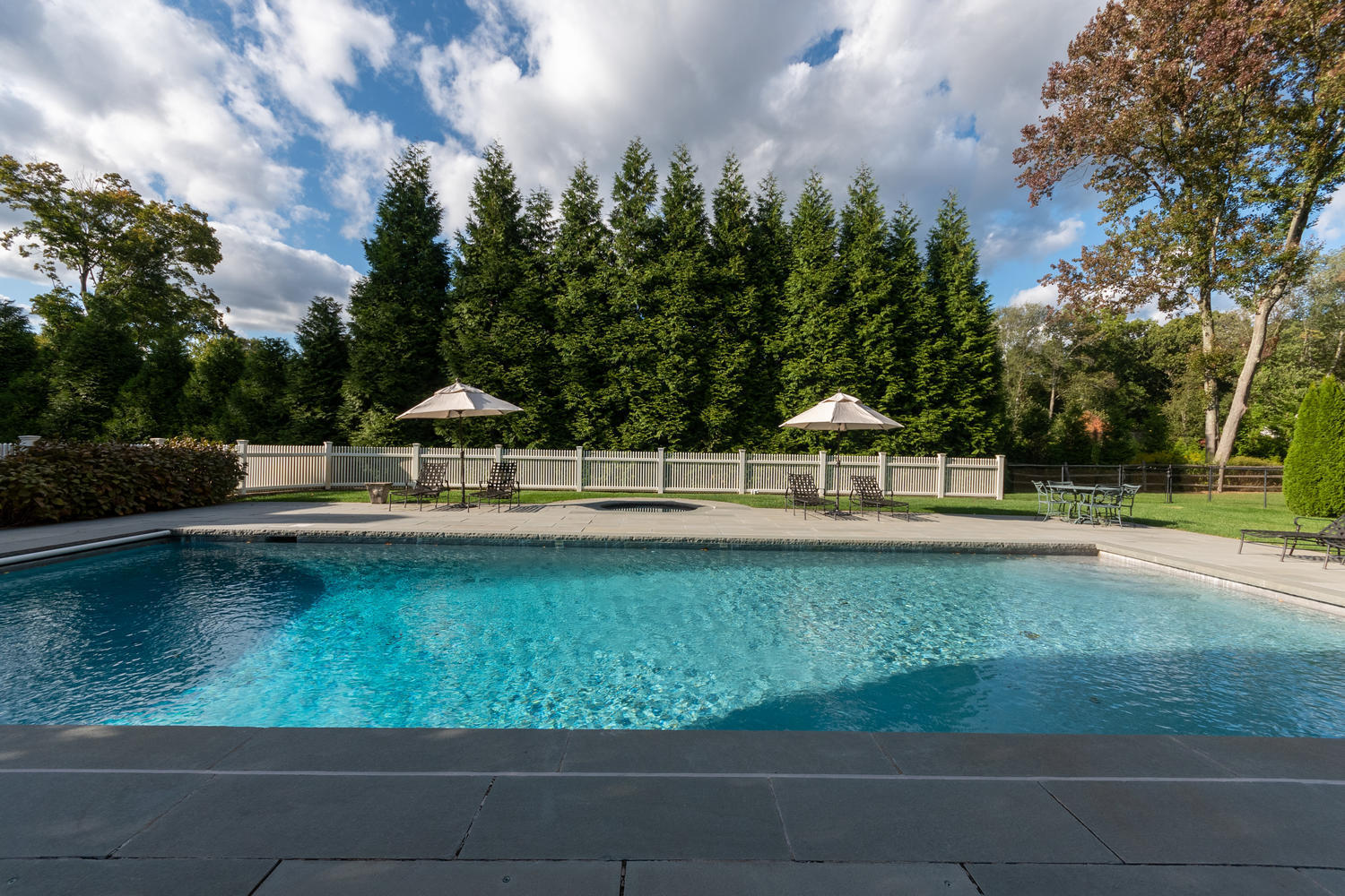 300 Brookside Road Darien, CT 06820 - Photo 50 of 58 a view of a swimming pool with a garden