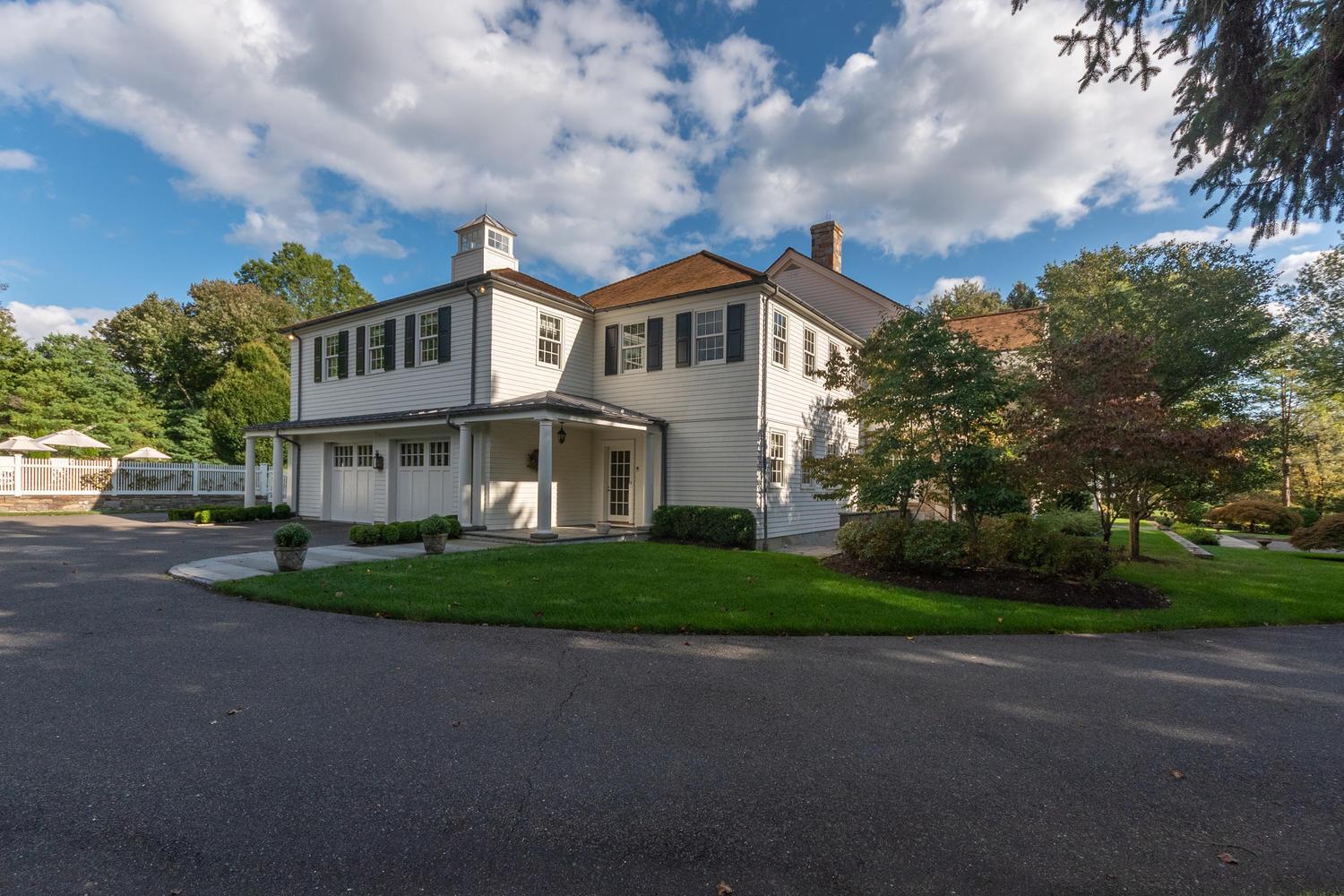 300 Brookside Road Darien, CT 06820 - Photo 5 of 58 a front view of a house with a garden and trees