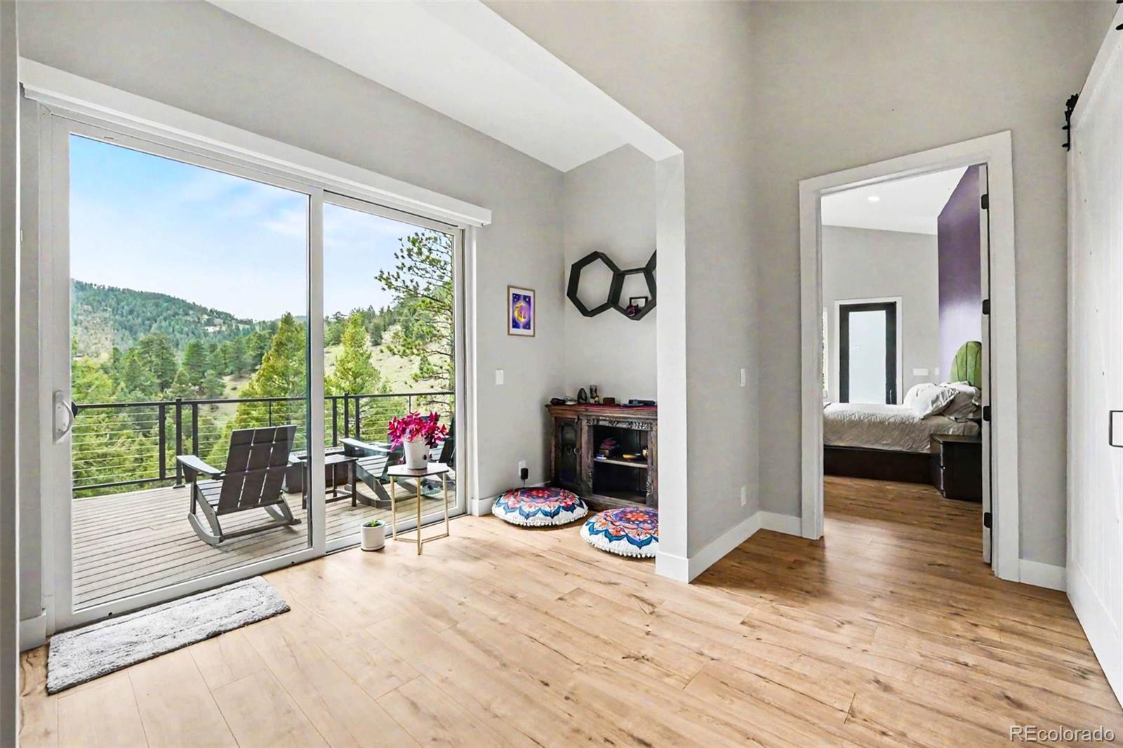 7231 Timber Trail Road Evergreen, CO 80439 - Photo 14 of 35 a living room with furniture and a large window
