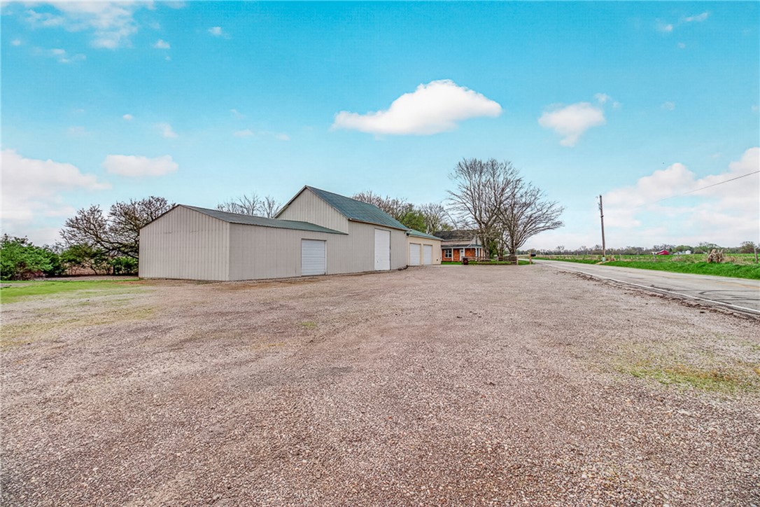 8700 Quaker Trace Road Camden, OH 45311 - Photo 29 of 34 This spacious property features a durable barn with multiple garage bays, ideal for storage or workspace.