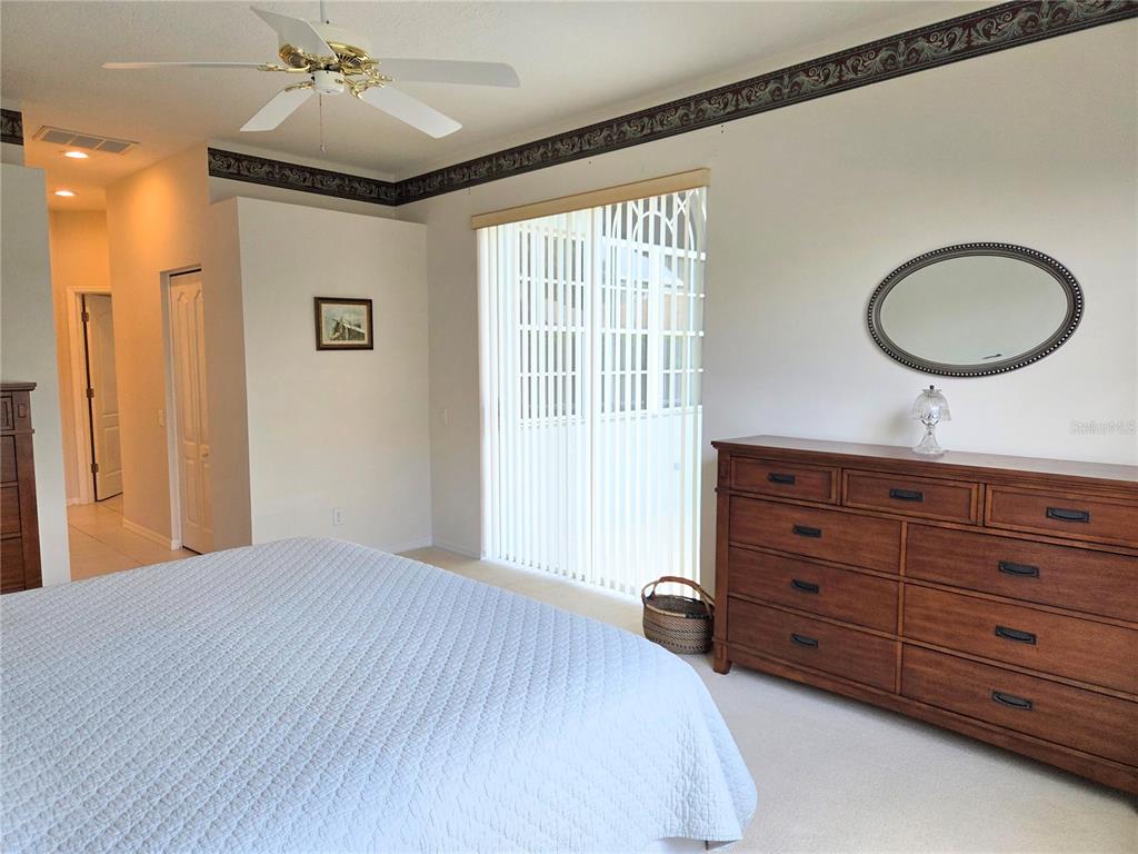 9222 Bonnington Drive Trinity, FL 34655 - Photo 16 of 37 a bedroom with a bed and a dresser