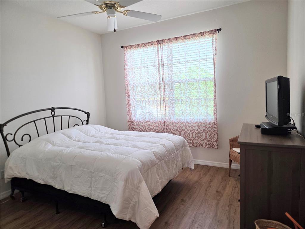 9222 Bonnington Drive Trinity, FL 34655 - Photo 20 of 37 a bedroom with a bed window and a table