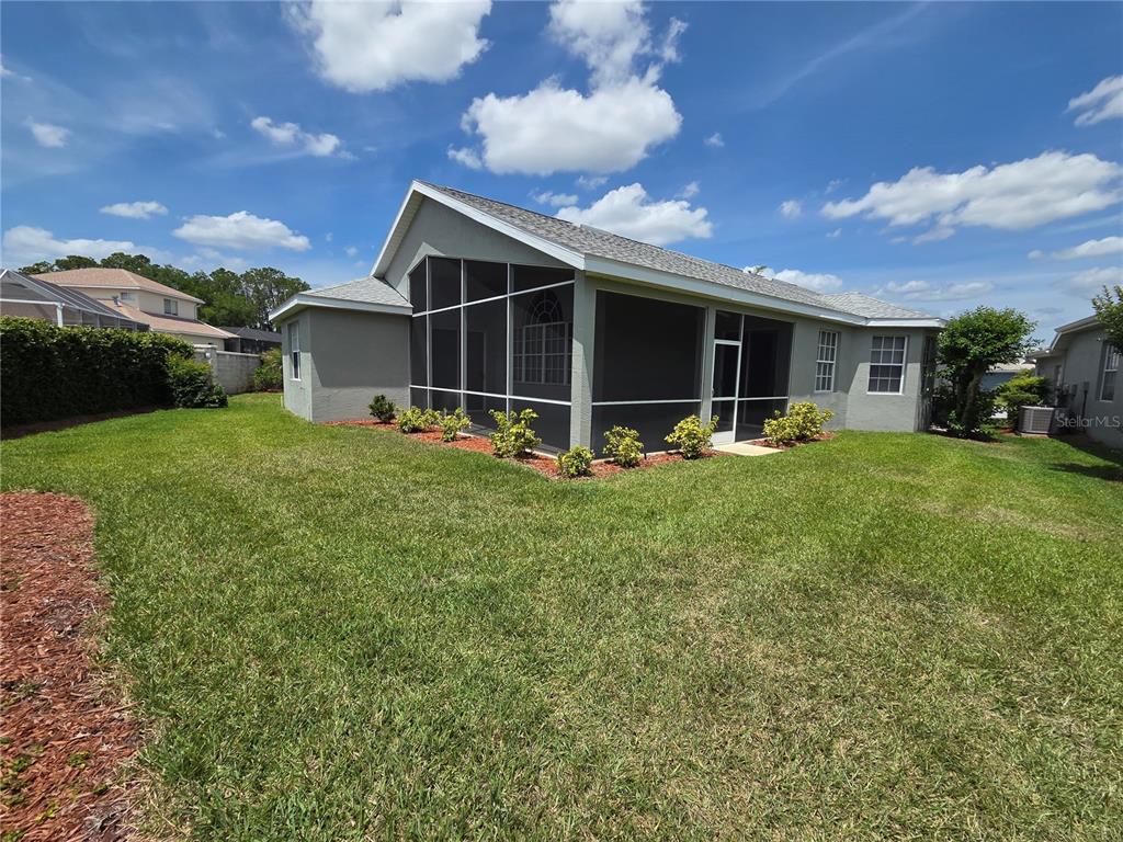 9222 Bonnington Drive Trinity, FL 34655 - Photo 31 of 37 a view of a backyard with table and chairs with a patio and garden