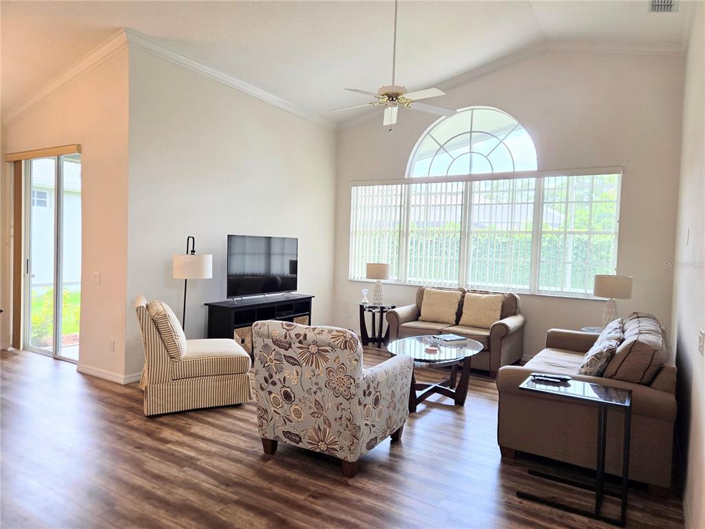 9222 Bonnington Drive Trinity, FL 34655 - Photo 4 of 37 a living room with furniture a flat screen tv and a large window