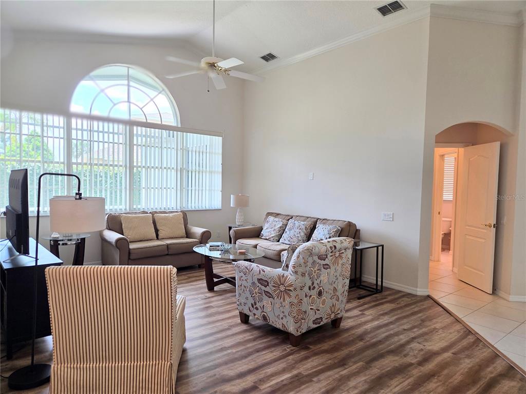 9222 Bonnington Drive Trinity, FL 34655 - Photo 5 of 37 a living room with furniture a large window and wooden floor