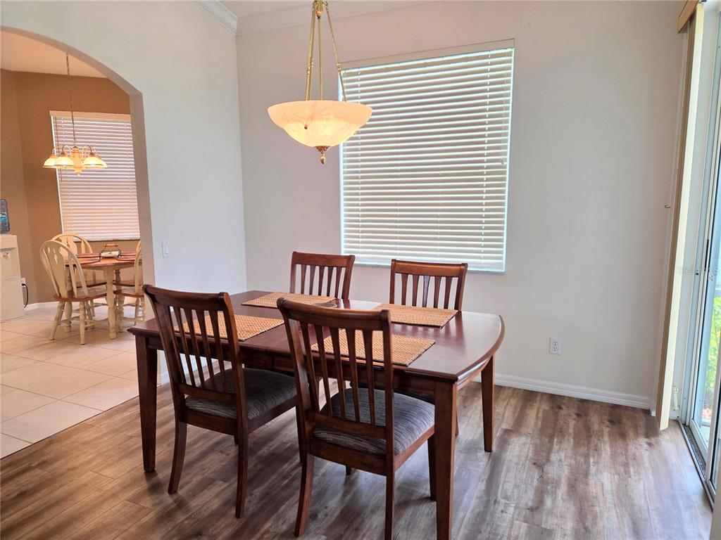 9222 Bonnington Drive Trinity, FL 34655 - Photo 6 of 37 a view of a dining room with furniture and wooden floor