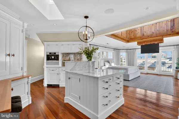 a spacious bedroom with a bed and a dresser