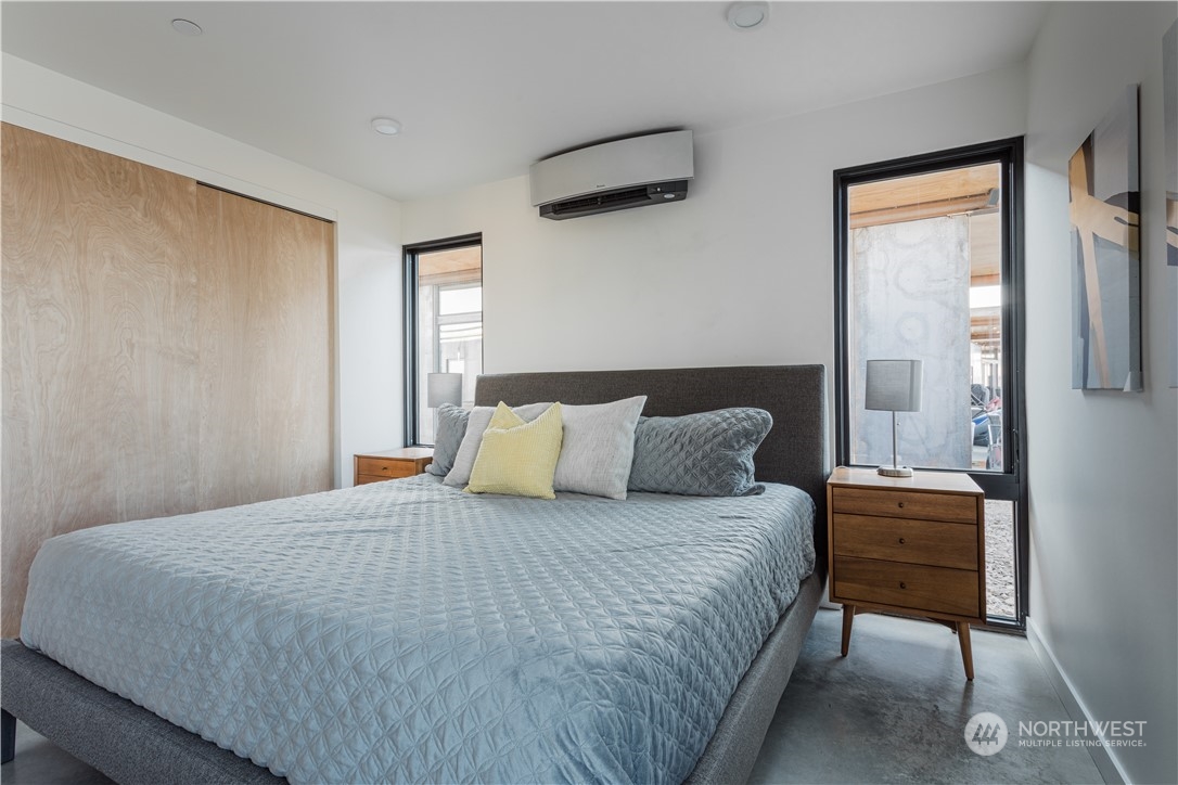 240 Northwest Rattlesnake Point Road Quincy, WA 98848 - Photo 18 of 37 a bedroom with a bed a lamp and a window