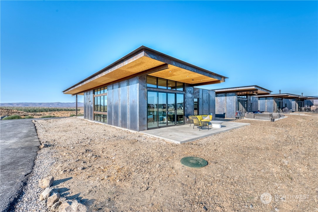 240 Northwest Rattlesnake Point Road Quincy, WA 98848 - Photo 3 of 37 a view of pool with lawn chairs under an umbrella