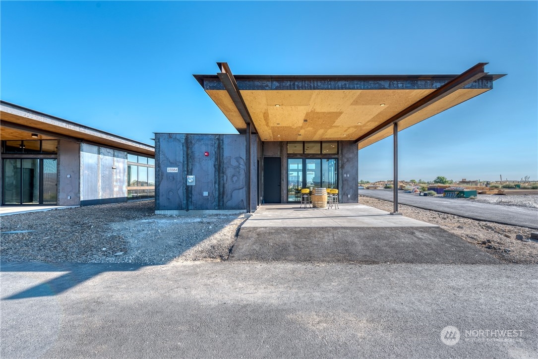 240 Northwest Rattlesnake Point Road Quincy, WA 98848 - Photo 32 of 37 a view of a house with a patio and a yard