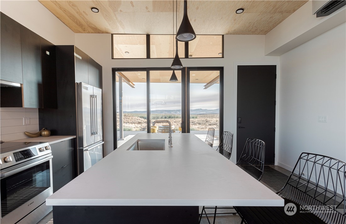 240 Northwest Rattlesnake Point Road Quincy, WA 98848 - Photo 5 of 37 a view of kitchen with furniture and large window