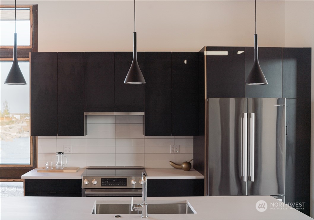 240 Northwest Rattlesnake Point Road Quincy, WA 98848 - Photo 7 of 37 a kitchen with a sink and refrigerator