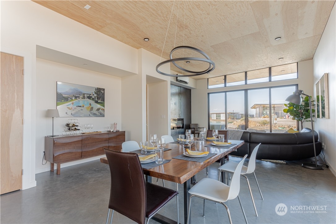 240 Northwest Rattlesnake Point Road Quincy, WA 98848 - Photo 8 of 37 a dining room with furniture a chandelier and a rug
