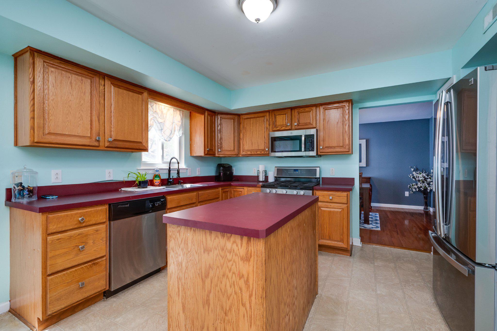 4870 Dunham Drive Reading, PA 19606 - Photo 26 of 59 a kitchen with stainless steel appliances granite countertop a stove top oven a sink dishwasher a microwave oven and a refrigerator