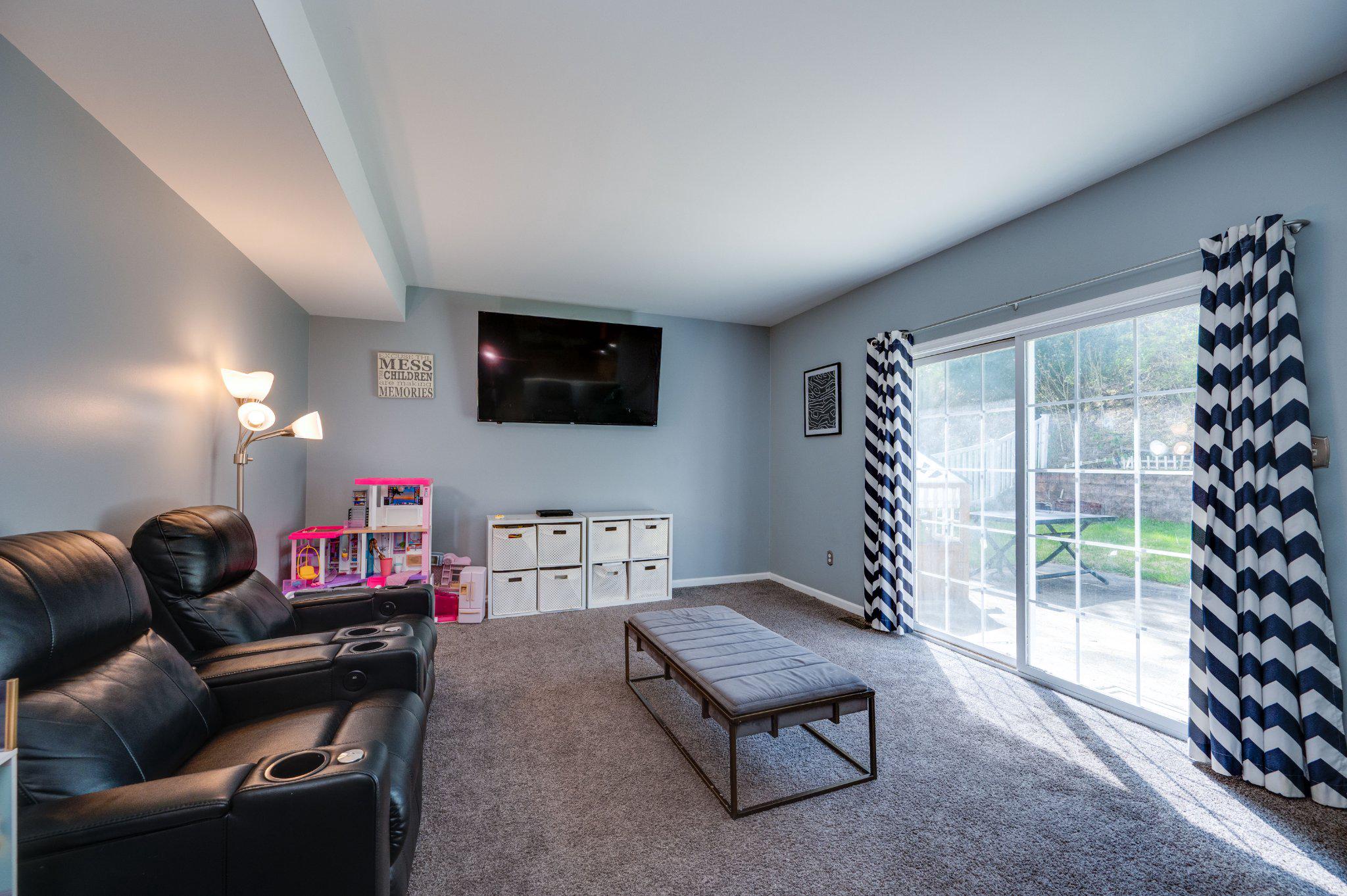 4870 Dunham Drive Reading, PA 19606 - Photo 32 of 59 a living room with furniture a flat screen tv and a window