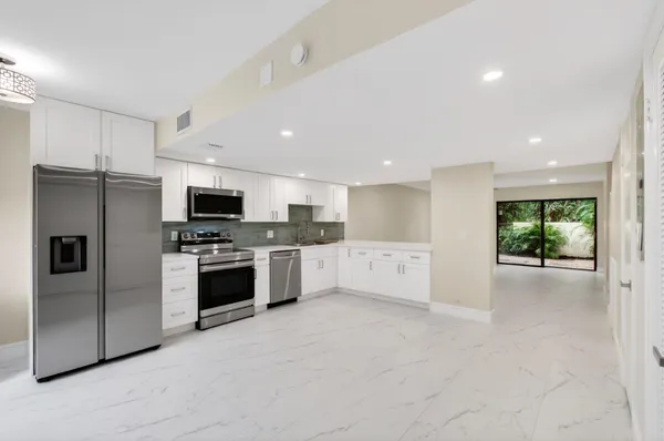 a kitchen with stainless steel appliances a refrigerator sink and stove