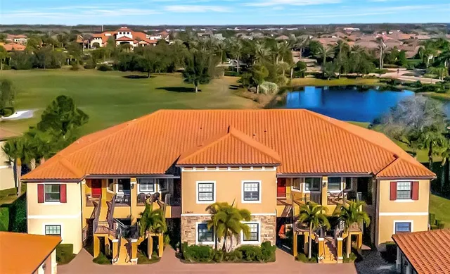an aerial view of a house with garden space and lake view