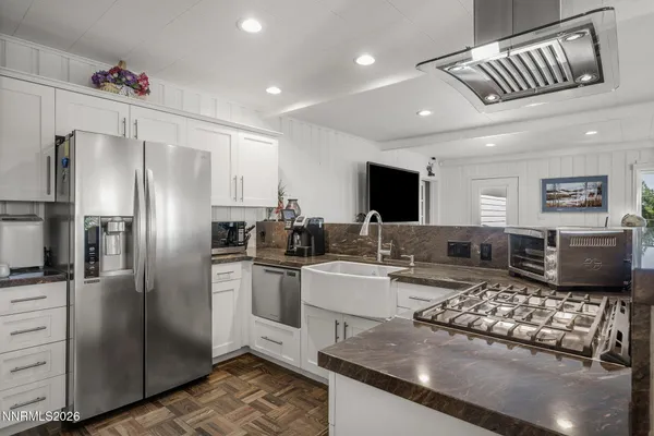 a kitchen with stainless steel appliances granite countertop a stove refrigerator and microwave