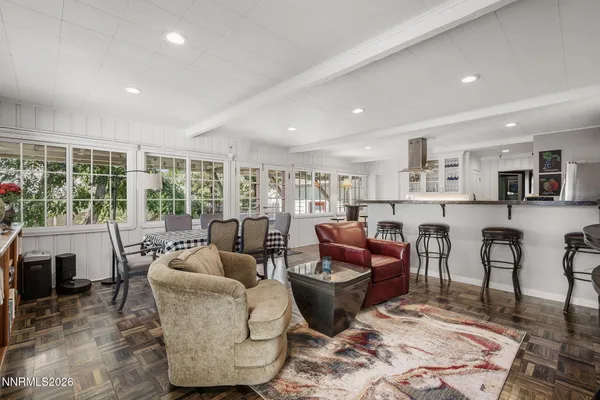 a living room kitchen with furniture and a large window