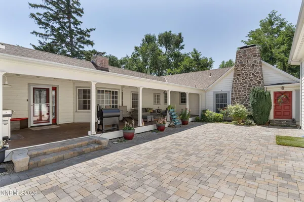 a view of a house with sitting area and garden
