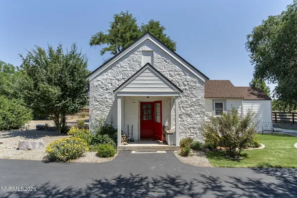 a front view of a house with a garden