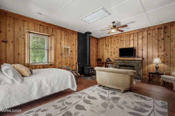 a bedroom with a bed and a flat screen tv