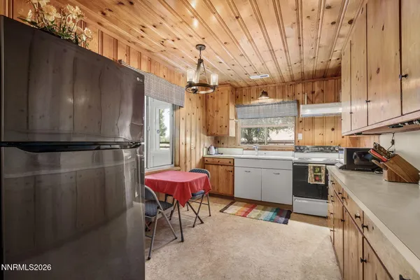 a kitchen with a sink appliances and cabinets
