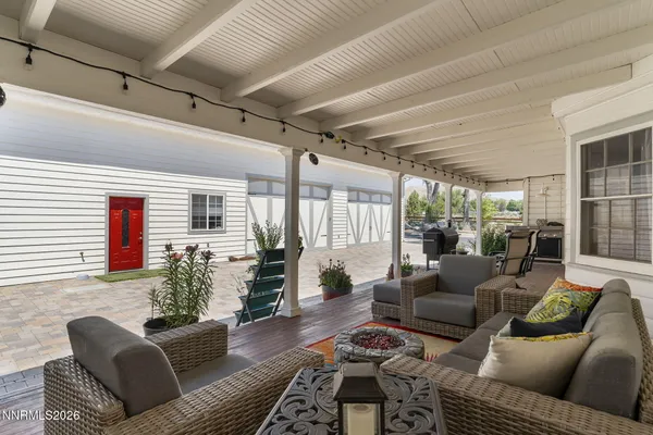 a view of a livingroom with furniture and a large window
