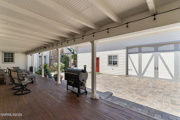 a backyard of a house with table and chairs