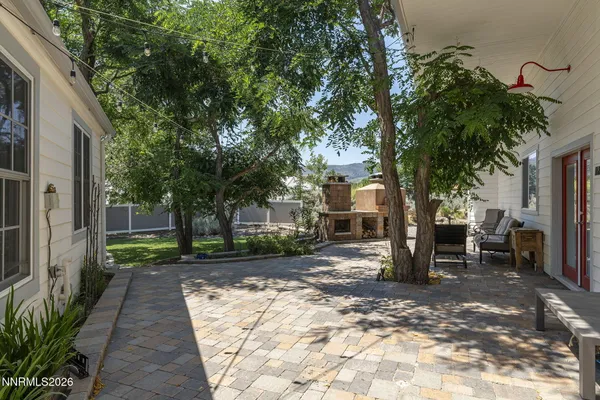 a view of a house with backyard sitting area and garden
