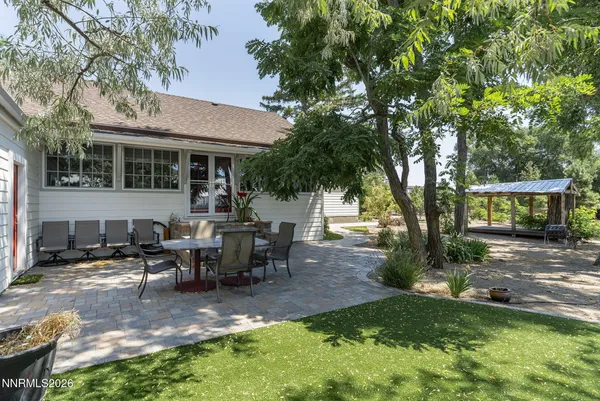 a view of a yard with a table and chairs