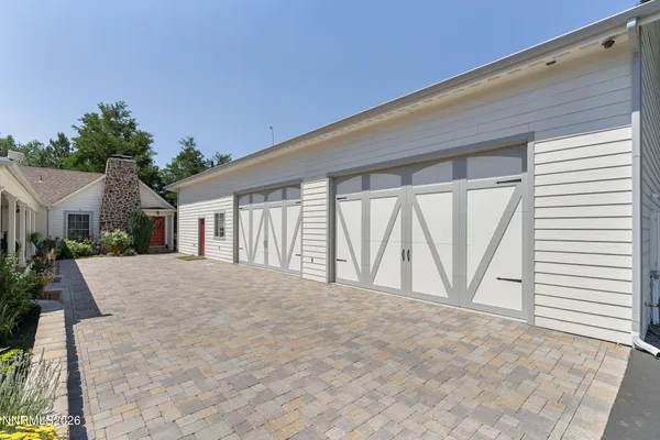 a view of an house with backyard and road