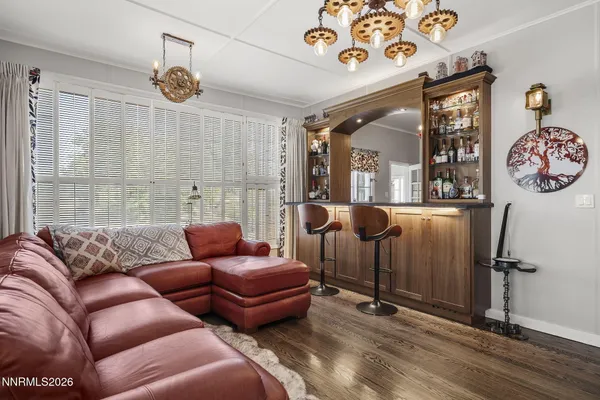 a living room with furniture a clock and a window