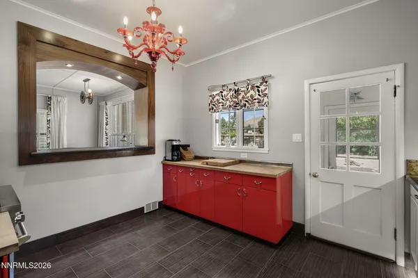 a spacious en suite bathroom with a granite countertop sink mirror and window