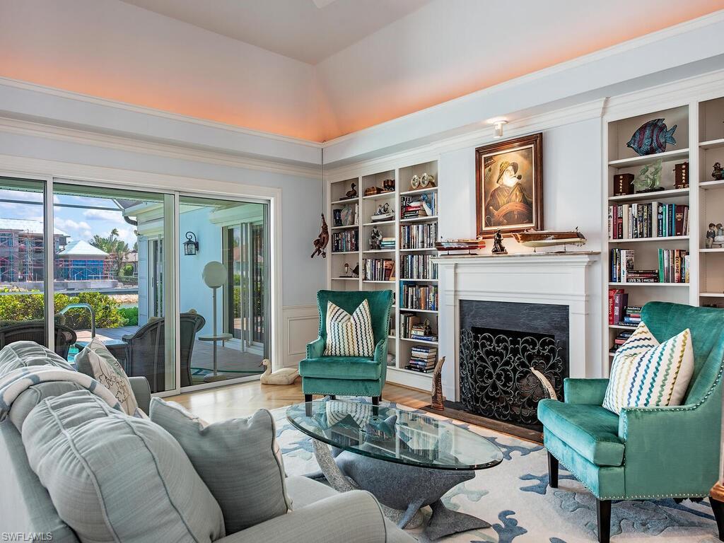 3495 Gin Lane Naples, FL 34102 - Photo 11 of 18 a living room with furniture and a fireplace
