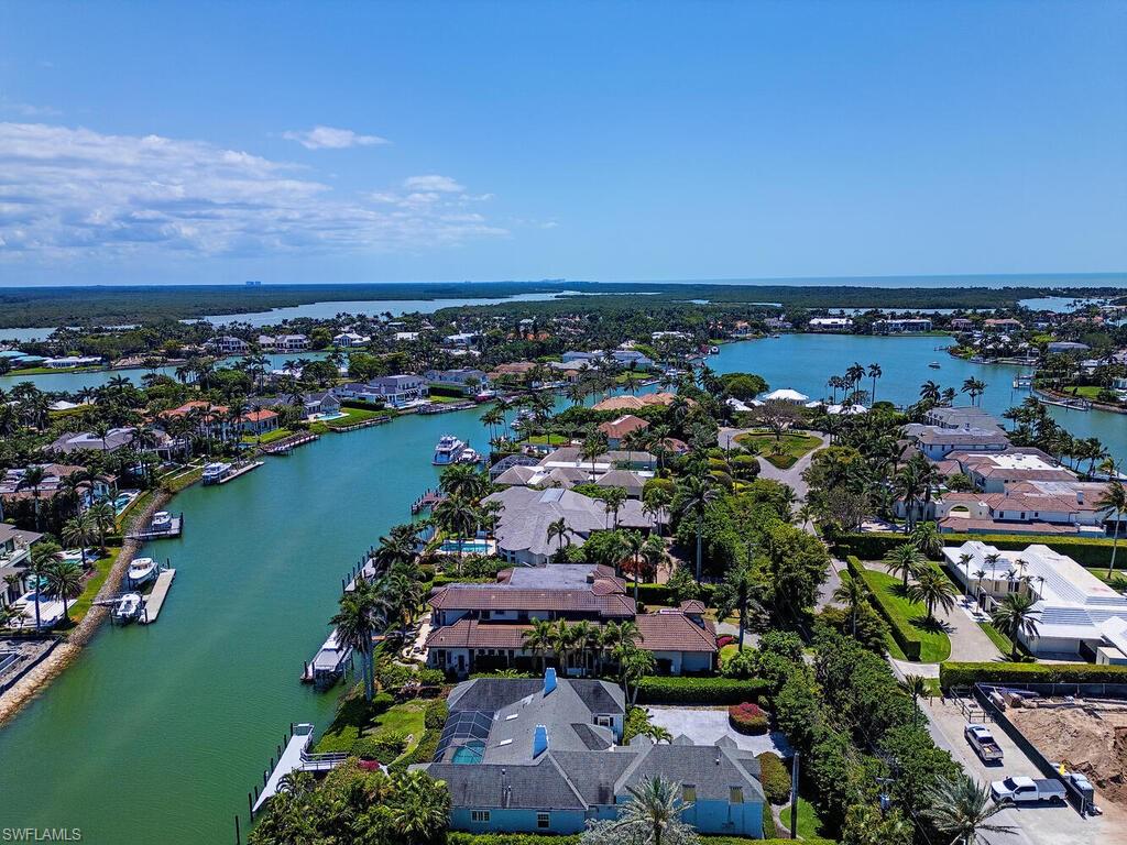 3495 Gin Lane Naples, FL 34102 - Photo 2 of 18 an aerial view of a city with lots of residential buildings and ocean view in back